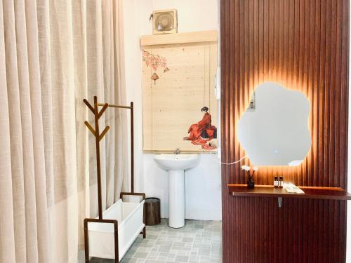 a bathroom with a sink and a mirror at Vangvieng Pool House Hotel in Vang Vieng
