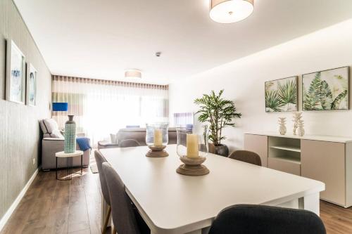 a dining room and living room with a white table and chairs at 2 bedrooms appartement with wifi at Fatima in Fátima