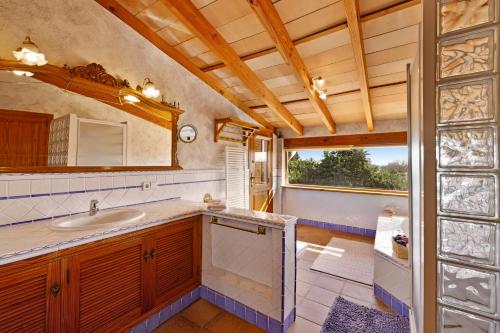 a bathroom with a sink and a mirror at Villa Can Font in Palma de Mallorca