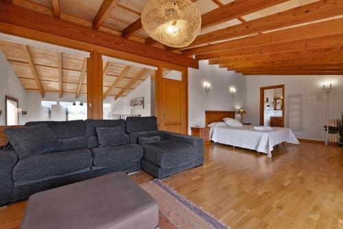 a living room with a couch and a bed at Villa Can Font in Palma de Mallorca