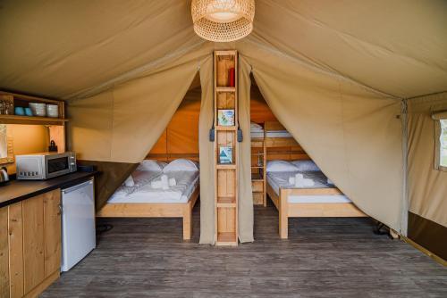 a room with two beds in a tent at Glamping Tents in Tuhelj with thermal riviera tickets in Tuheljske Toplice