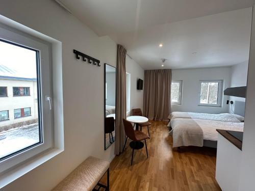 a hotel room with a bed and a table and a window at Edsviken Hotell AB in Stockholm