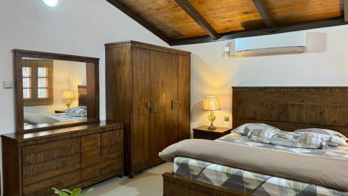 a bedroom with two beds and a large mirror at A Luxury Duplex in Dili City, Timor-Leste in Dili