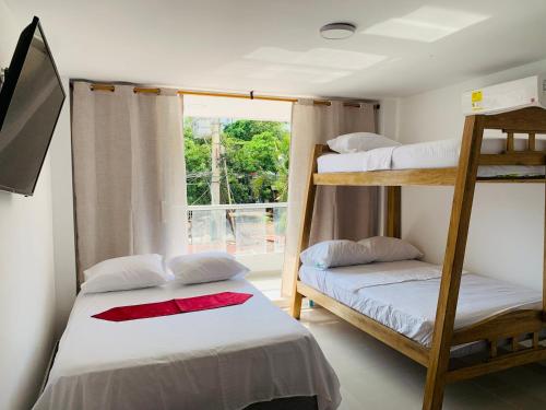 two bunk beds in a room with a window at Hotel Belmar piso 2 in Cartagena de Indias