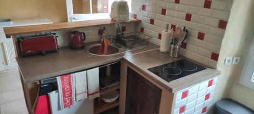 a small kitchen with a sink and a counter at Talvern, Les Mouettes à Landévant in Landévant
