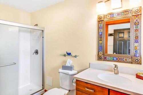 a bathroom with a toilet and a sink and a mirror at Whale Song Condo #29 in Moclips
