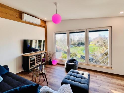 a living room with a couch and a tv at Fewo im Taubenhaus in Bad Lausick