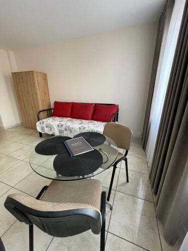 a table and chairs in a room with a bed at Ratuszowa 13 in Prudnik