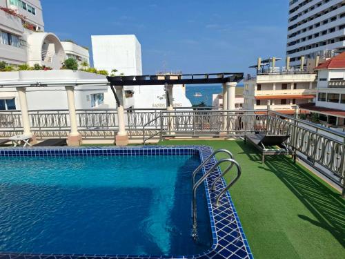 a swimming pool on the balcony of a building at Whitehouse Condotel in Pattaya