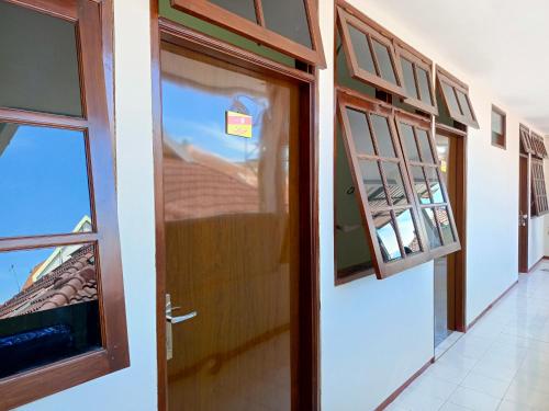 an open door in a room with a window at Bebek Kuning Residence in Blimbing