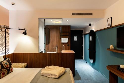 a bedroom with a bed and a bathroom at Hôtel Roz Marine Thalasso Resort in Perros-Guirec