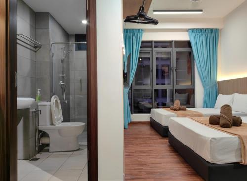 two beds in a room with a shower and a bathroom at Near Airport K Avenue Family Room in Donggongon