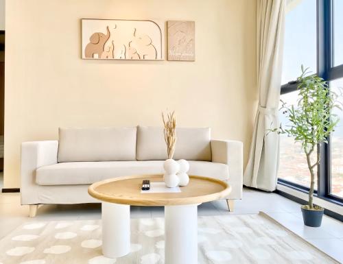 a living room with a couch and a table at Urban Suites George Town in Jelutong