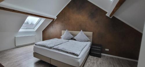 a small bedroom with a bed in a attic at Gasthaus Sürder Hof in Grevenbroich