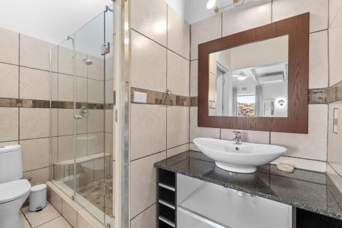 a bathroom with a sink and a toilet and a mirror at San Lameer Villa 3122 - 3 Bedroom Classic - 6 pax - San Lameer Rental Agency in Southbroom