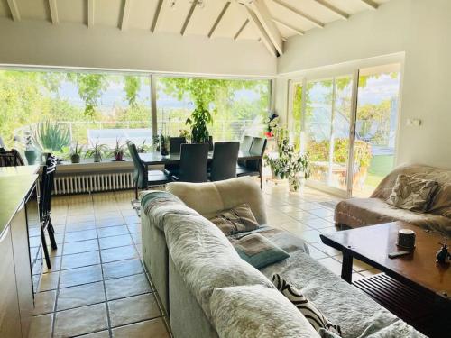 a living room with a couch and a table at Villa avec piscine au cœur de la ville in Tournon-sur-Rhône