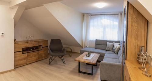 a living room with a couch and a table at Ferienwohnung Schönblick in Weissenbach am Lech
