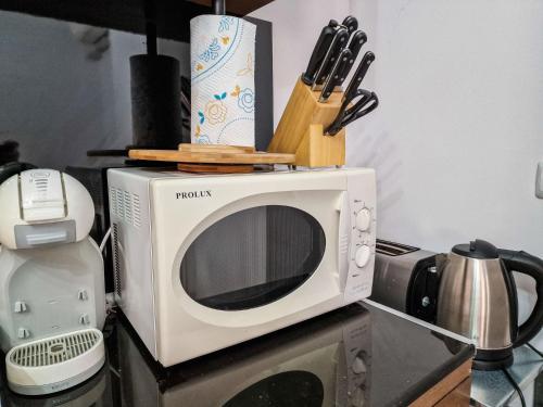 a microwave sitting on top of a kitchen counter at Cedar Lodge 2 Bedroom Apartment by Flat Mаnager in Bansko
