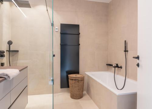 a bathroom with a shower and a bath tub at DAS GRIES in Schladming