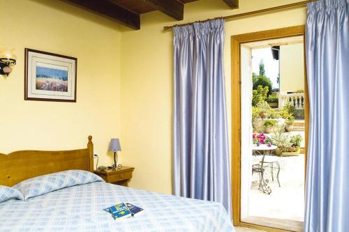 a bedroom with a bed and a sliding glass door at Holiday homes Santa Margalida - BAL01422-FYB in Santa Margalida