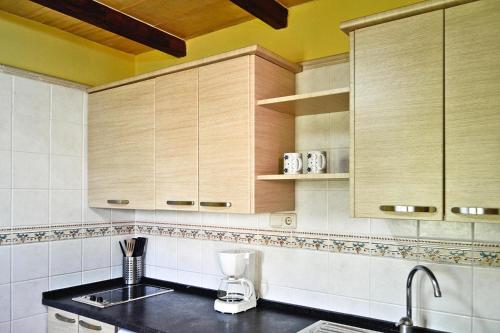 a kitchen with wooden cabinets and a counter top at Holiday homes Santa Margalida - BAL01422-FYB in Santa Margalida