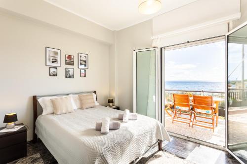 a bedroom with a bed and a view of the ocean at Sunset Serenity - Kardamili Seaside Getaway in Kardamili