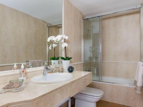 a bathroom with a sink and a toilet and a mirror at Bonanza 5 - Apartment In Colònia De Sant Jordi Free Wifi in Colònia de Sant Jordi