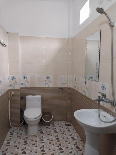 a bathroom with a toilet and a sink at Tom's House in Hòa Bình