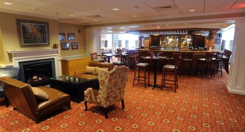 a bar in a restaurant with a fireplace at Deerfield Inn in Deerfield