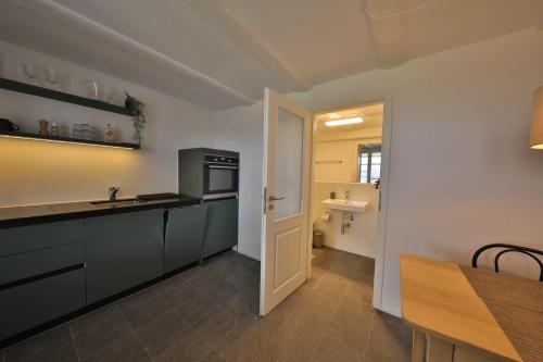 a kitchen with a sink and a stove top oven at Union Apartments Bern-Belp in Belp