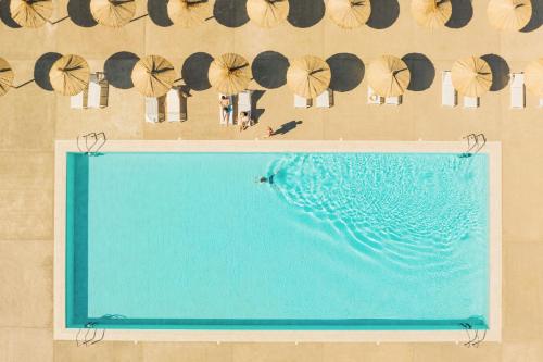 una vista sul tetto di una piscina con ombrelloni di Résidence Pierre & Vacances Premium Domaine du Golfe du Lion a Saint-Cyprien