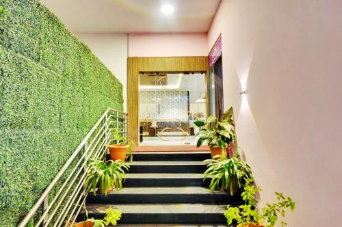 a staircase with potted plants in a building at Inaara Hotel, Bangalore in Bangalore