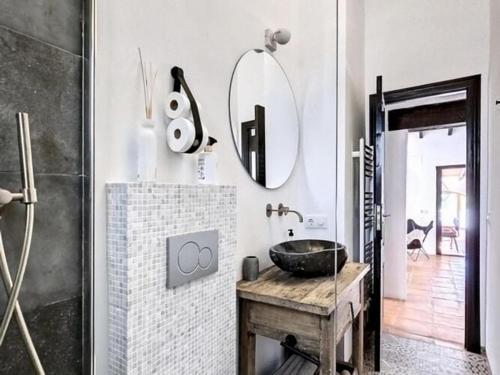 a bathroom with a sink and a mirror at Spacious Retreat with Games in Benissa