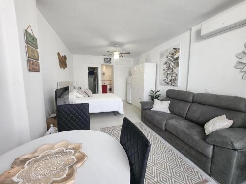 a living room with a couch and a table and a bed at Beautiful Apartment in Almer a with Swimming Pool in Playas de Vera