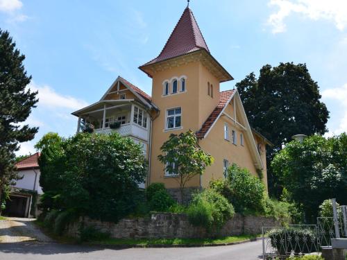 ein großes gelbes Gebäude mit einem Turm auf einer Straße in der Unterkunft Modern apartment in a listed villa with beautiful view from balcony in Bad Suderode