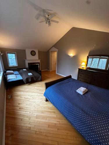 a bedroom with a blue bed and a ceiling at Executive Suite in a Victorian Style Bungalow P4b in Pickering