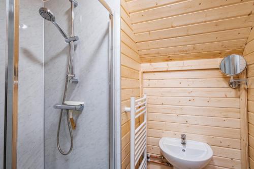 a bathroom with a shower and a sink at Cairngorm Bothies in Aboyne