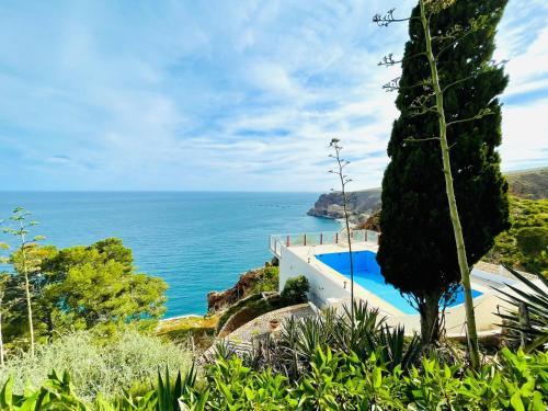 a villa with a view of the ocean at Seafront apartment in La Garrofa near the beach in La Garrofa