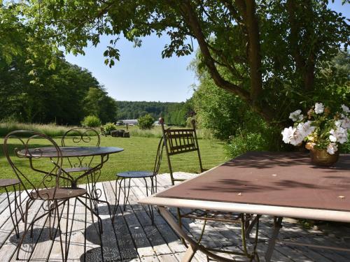 a table and two chairs and a table and a table and chairs at Holiday Home in Auvergne with Roofed Garden and Terrace in Calvinet