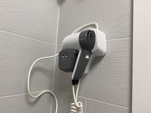 a hair dryer is attached to a wall at Apartamentos TARELA Porriño in Porriño