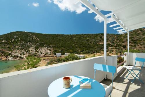 a cup of coffee sitting on a table on a balcony at Ammos 2 - Seafront maisonette, Glyfo beach, Sifnos in Chrisopigi
