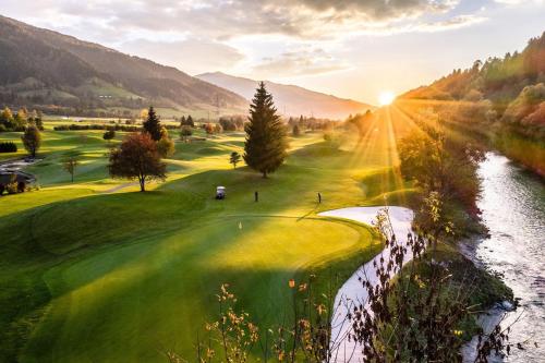 a view of a golf course with a river at DAS GRIES in Schladming