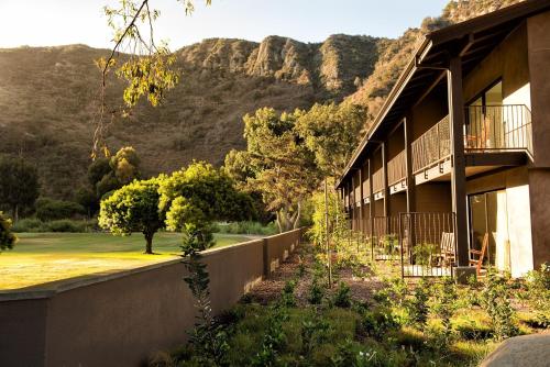 a building with a mountain in the background at The Ranch at Laguna Beach in Laguna Beach