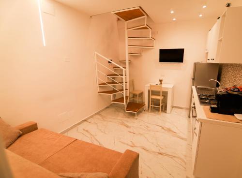 uma sala de estar com uma escada em espiral numa cozinha em La casa di anna em Nápoles