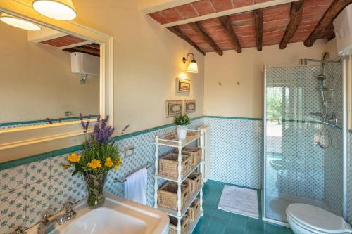 a bathroom with a sink and a shower and a toilet at Villa Bellavista - Homelike Villas in Cavriglia