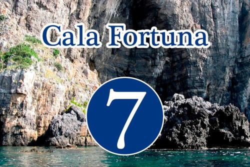 a sign that reads cala tortuna on a cliff at La Locanda del Curato Rooms in Lentiscosa
