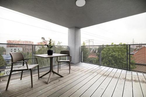 a room with a table and chairs on a balcony at AboutArtApartments - Otyńska 4 in Wrocław