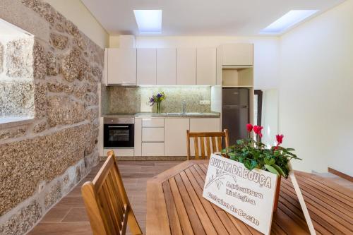 a kitchen and dining room with a table with a sign on it at Casa Ponte da Vessada in Celorico de Basto