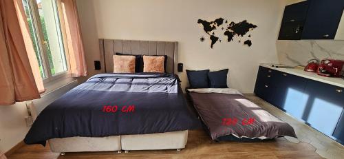 a bedroom with two twin beds with clocks on the wall at Escapade Parisienne - PARIS ORLY in Orly