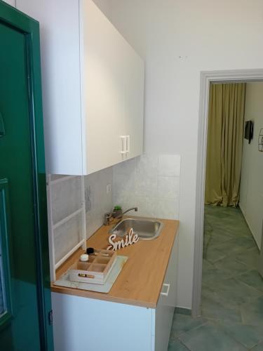 a kitchen counter with a sink in a room at spyridoula studio in Paleokastritsa